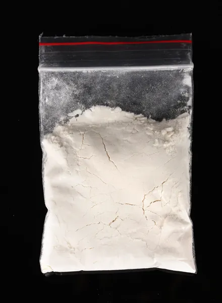 Kokain v balíčku na černém pozadí — Stock fotografie