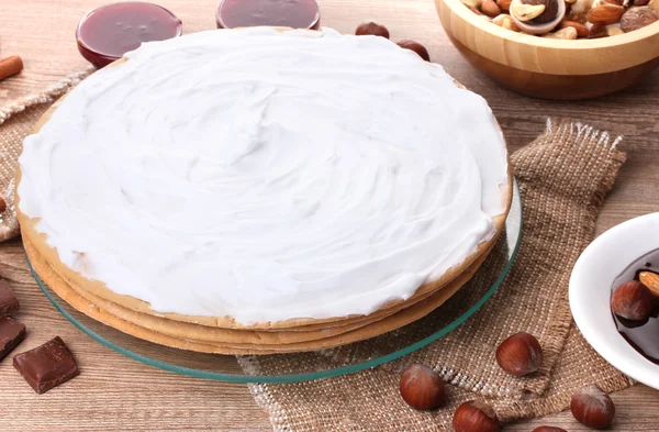 Stock image Cake on glass stand and nuts on wooden table