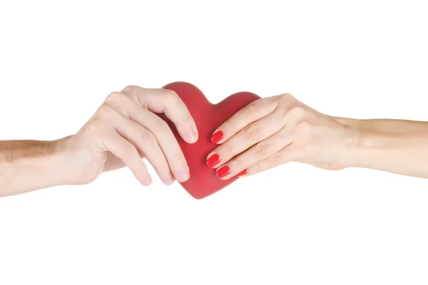 Man and woman holding red heart in hands isolated on white — Stock Photo, Image