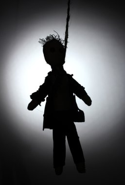 Hanged doll voodoo boy-groom on grey background clipart