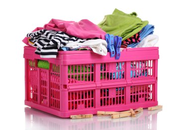 Clothes in pink plastic basket isolated on white clipart