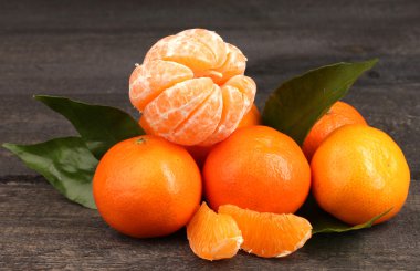 Tangerines with leaves on wooden grey table