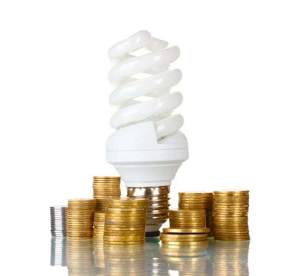 Úsporná lampa a peníze izolovaných na bílém — Stock fotografie