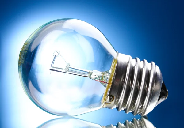 Light bulb on blue background — Stock Photo, Image