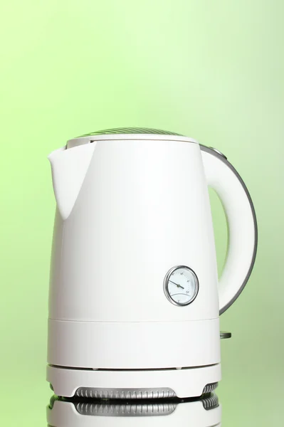White electric kettle on green — Stock Photo, Image