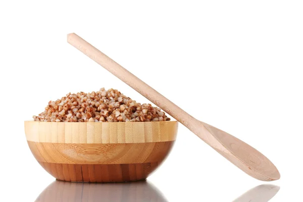 Boiled buckwheat in a wooden bowl isolated on white — Stock Photo, Image