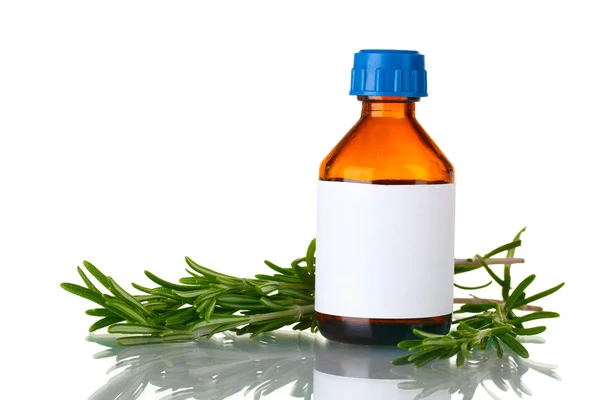 Медицинская бутылка и свежий зеленый розмарин изолированы на белом — стоковое фото