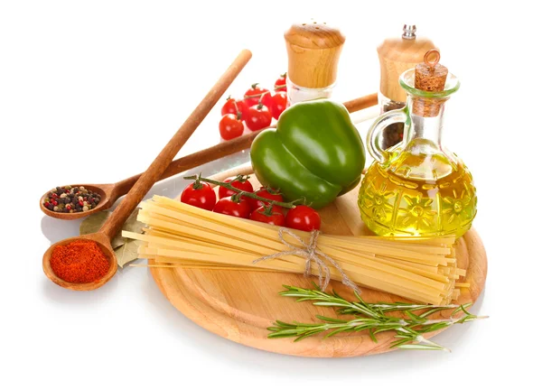 Spaghetti, jar of oil, spices and vegetables on wooden board isolated on wh — Stock Photo, Image