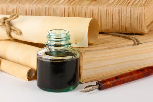 Old books, ink pen and ink bottle isolated on white — Stock Photo, Image