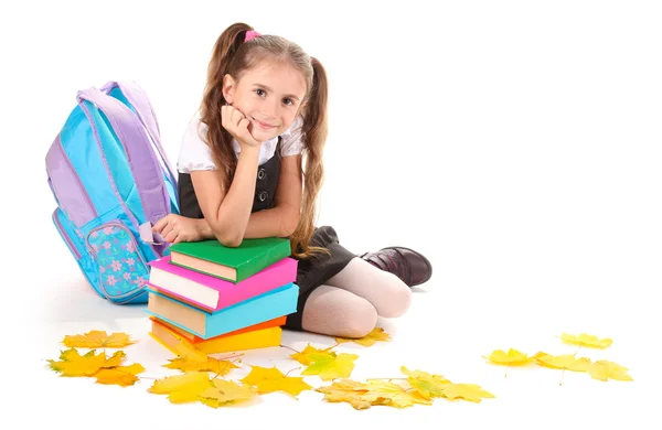 Beautiful little girl, books and a backpack isolated on white — Stock Photo, Image