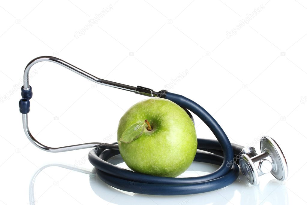 Medical stethoscope and green apple isolated on white