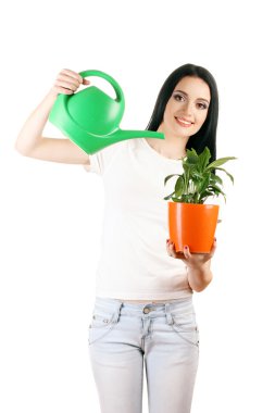 Beautiful young girl holding home plant and watering can isolated on white clipart