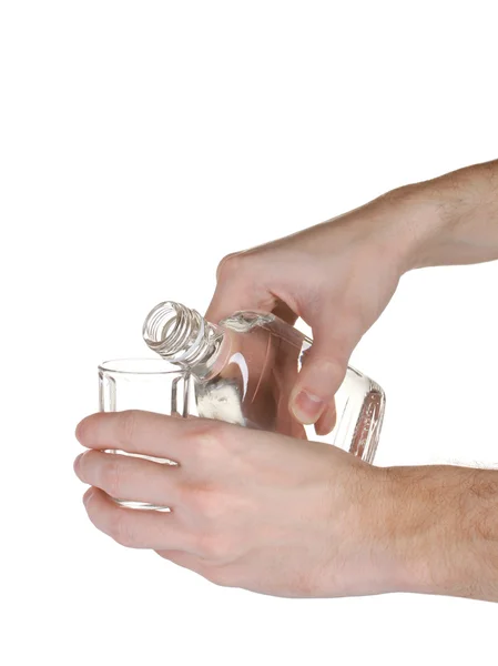 Vodka derramado em um copo isolado em branco — Fotografia de Stock
