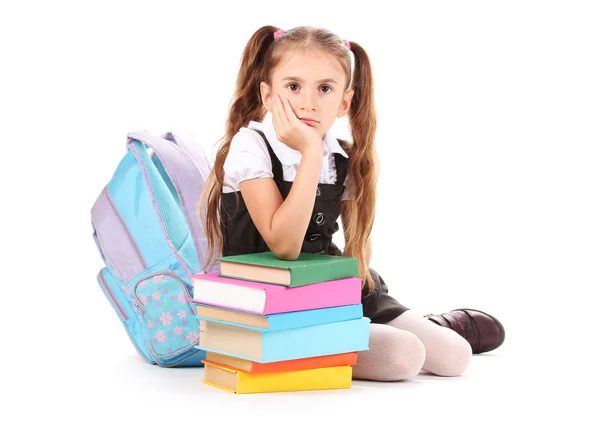 Hermosa niña, libros y una mochila aislada en blanco — Foto de Stock