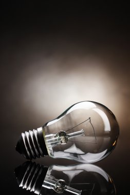 Light bulb on brown background clipart