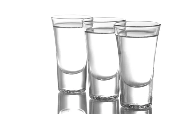 Tres vasos de vodka aislados en blanco —  Fotos de Stock