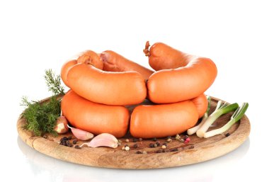 Tasty sausages on wooden board and spices isolation on white clipart