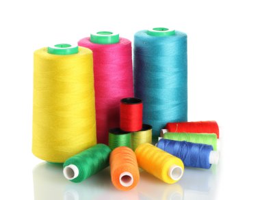 Many-coloured bobbins of thread isolated on white clipart