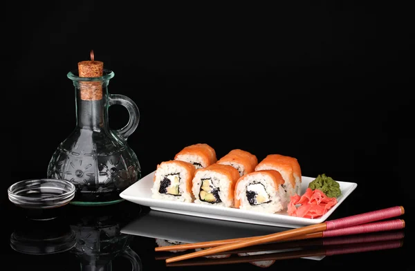 Tasty rolls served on white plate with chopsticks and soy sauce isolated on — Stock Photo, Image