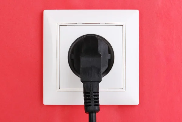 stock image White electric socket with plug on the wall