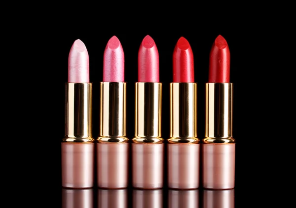 Beautiful lipsticks on black background — Stock Photo, Image