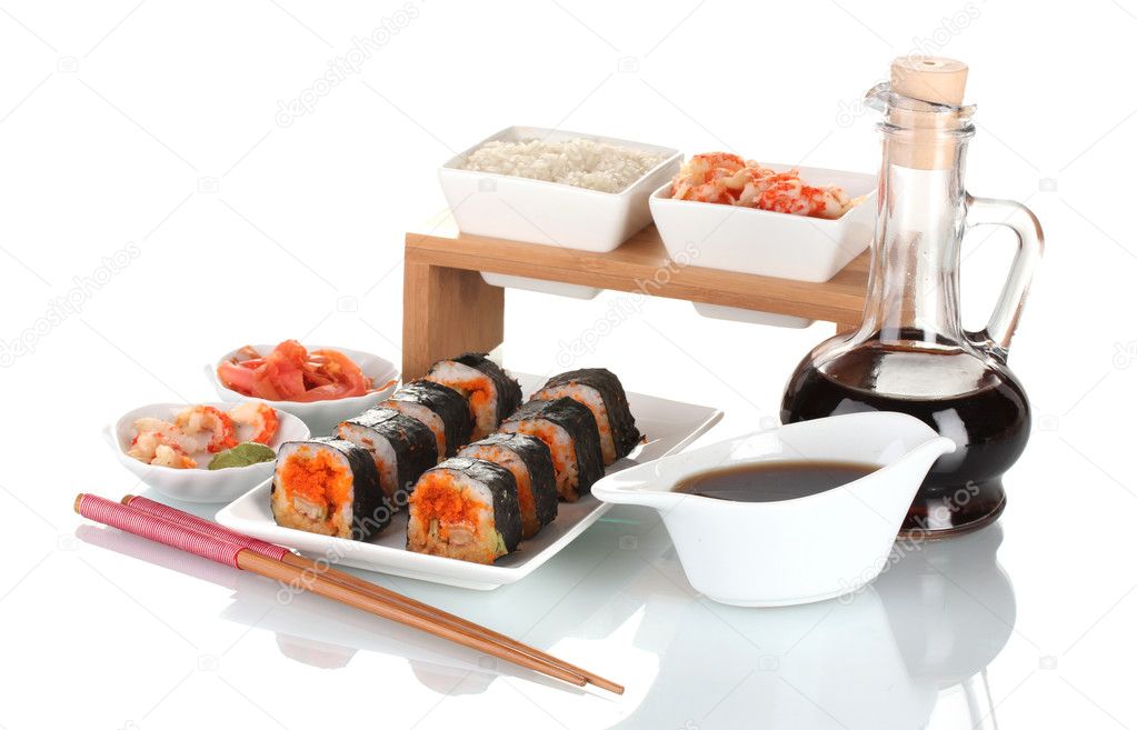 Delicious sushi on plate, chopsticks, soy sauce, fish and shrimps isolated