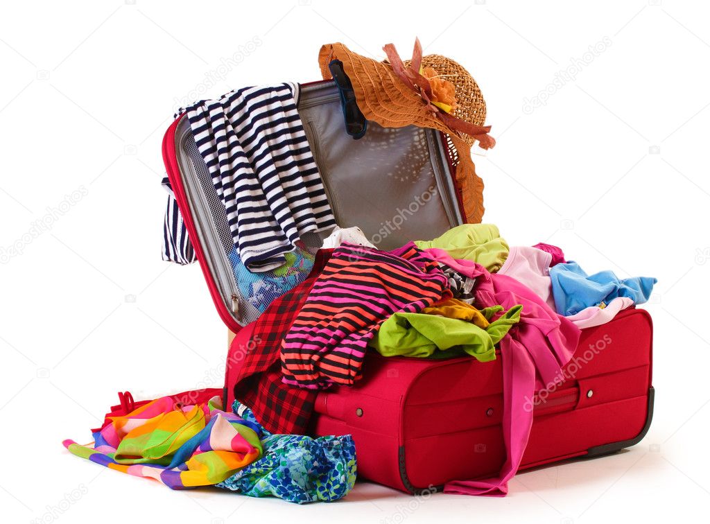 Open red suitcase with clothing isolated on a white
