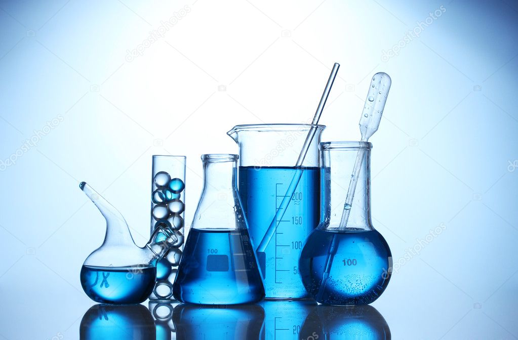 Test-tubes with blue liquid on blue background