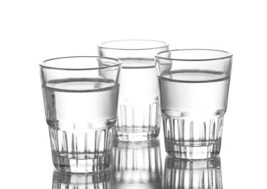 Three glass of vodka isolated on white clipart