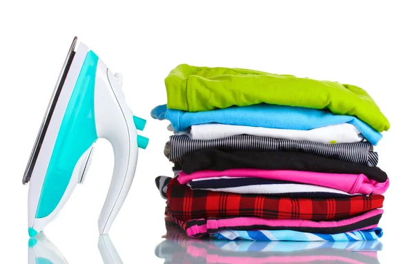 Pile of colorful clothes and electric iron isolated on white — Stock Photo, Image