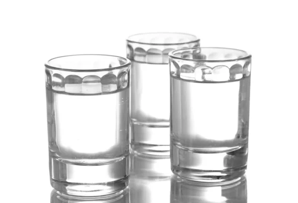 Três copos de vodka isolados em branco — Fotografia de Stock
