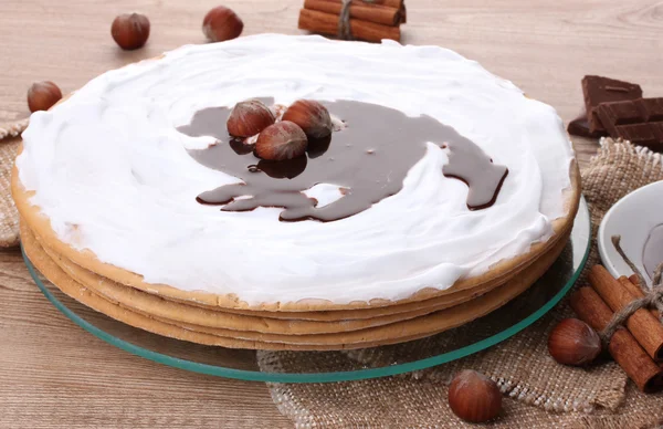 stock image Cake on glass stand and nuts on wooden table