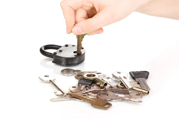 Selecting key to padlock isolated on white — Stock Photo, Image