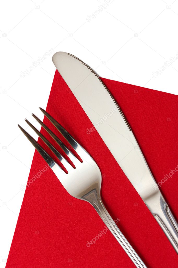 Fork and knife in a red cloth isolated on white