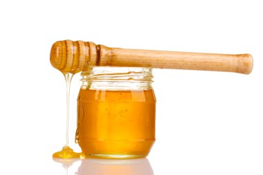 Jar of honey and wooden drizzler isolated on white clipart