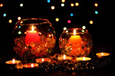 Wonderful composition of candles on wooden table on bright background clipart