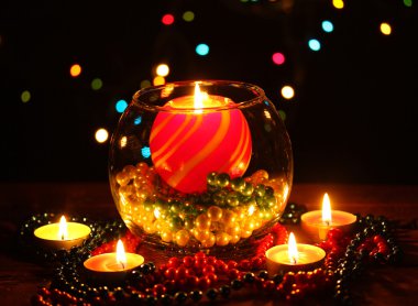 Wonderful composition with candle in glass on wooden table on bright background clipart