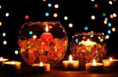 Wonderful composition of candles on wooden table on bright background clipart