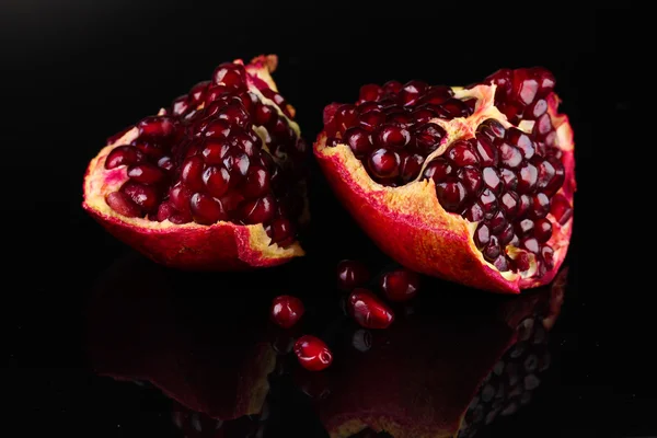 Ripe pomegranate fruit on black background — Stock Photo, Image
