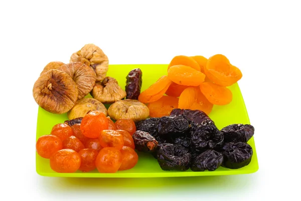 Deliziosi frutti secchi su piatto isolato su bianco — Foto Stock