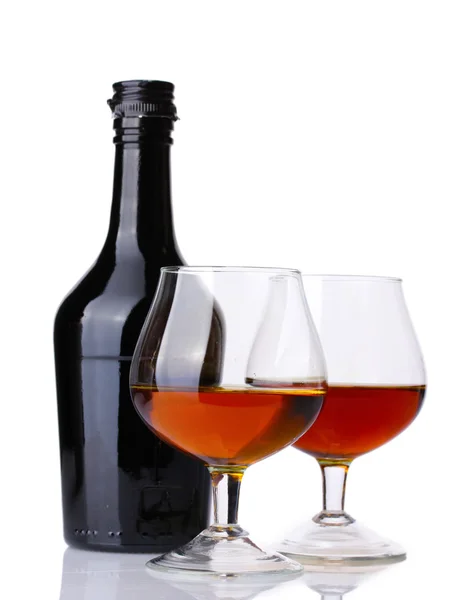 Vasos de brandy y botella aislados en blanco —  Fotos de Stock