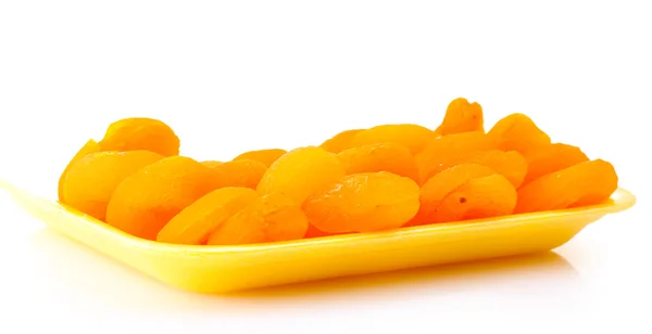 Delicious dried apricots in packaging isolated on white — Stock Photo, Image