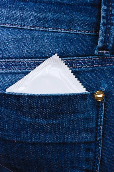 Condom in the pocket of blue jeans — Stock Photo, Image