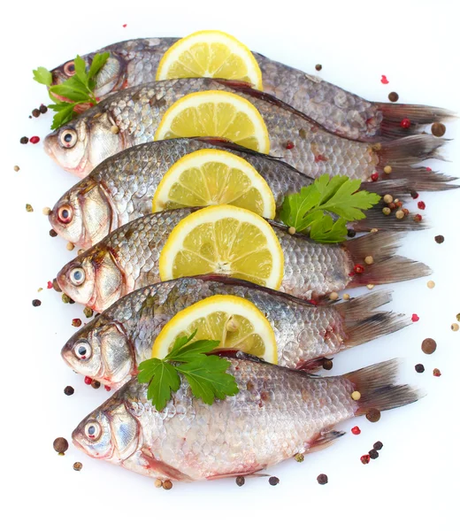 stock image Fresh fishes with lemon, parsley and spice isolated on white