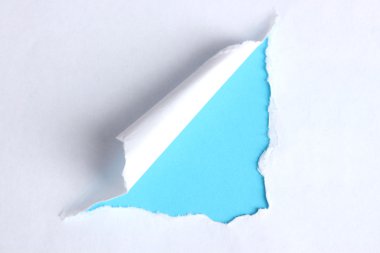 Torn paper with blue background clipart