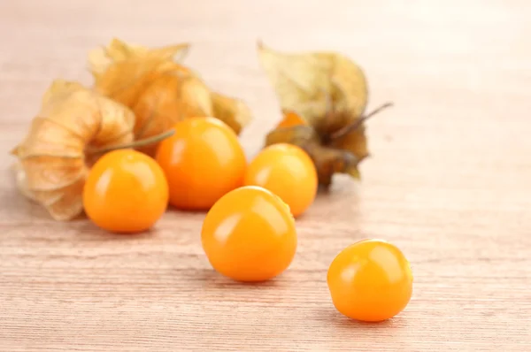 Physalis heap on wooden background — Stock Photo, Image