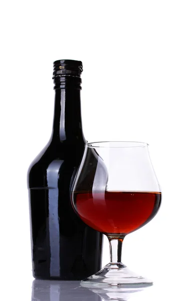 Glas brandy en fles geïsoleerd op wit — Stockfoto