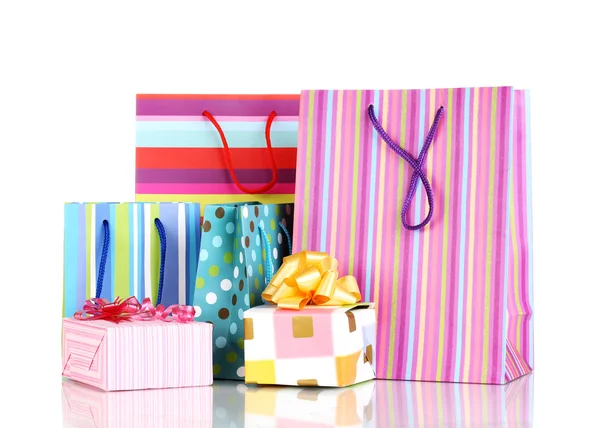Colorful gift bags with gifts isolated on white — Stock Photo, Image