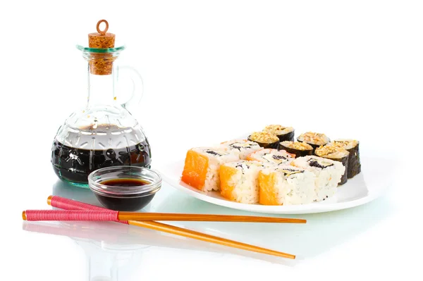 Tasty rolls served on white plate with chopsticks and soy sauce isolated on white — Stock Photo, Image