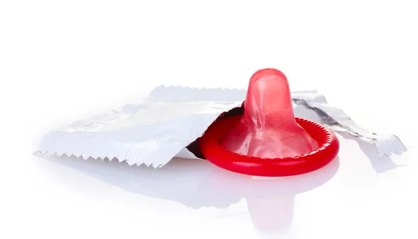Red condom with open pack isolated on white — Stock Photo, Image